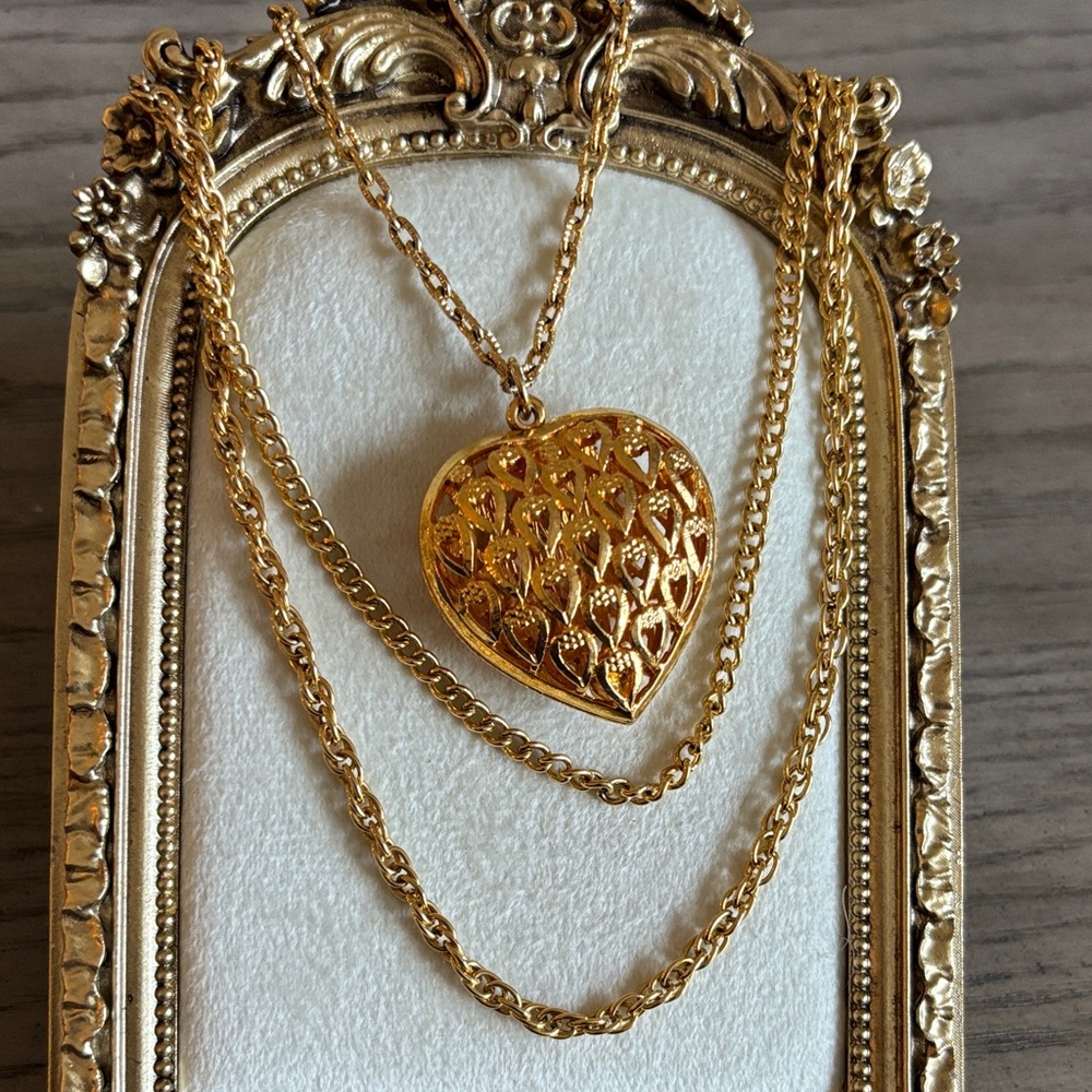 vintage-style gold-tone heart locket necklace with an ornate filigree design